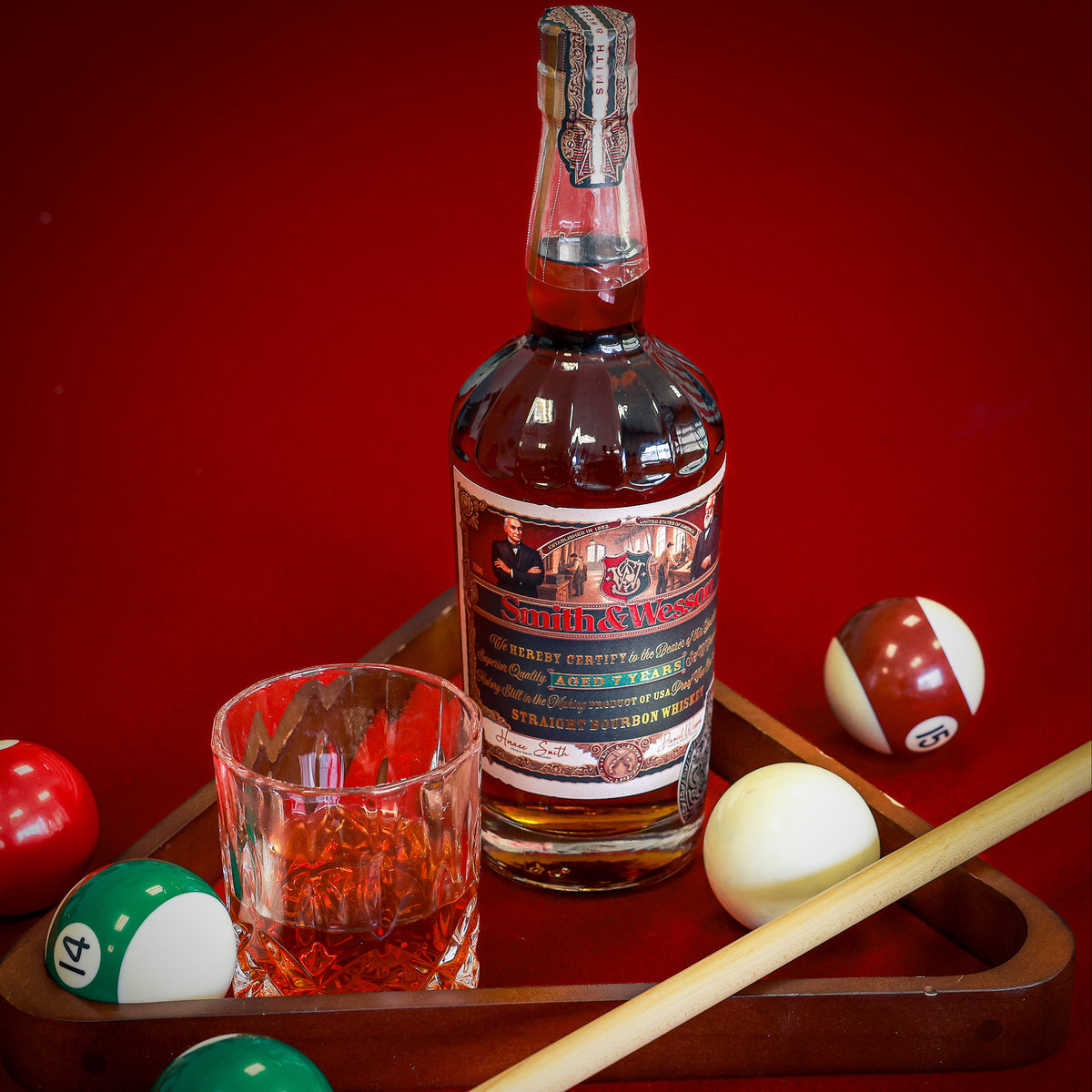 Smith & Wesson™ classic collection on red pool table with pool balls and stick